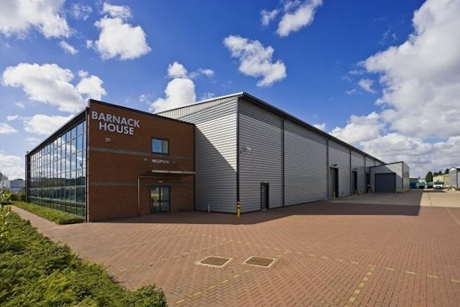 A large barn style warehouse with office attached